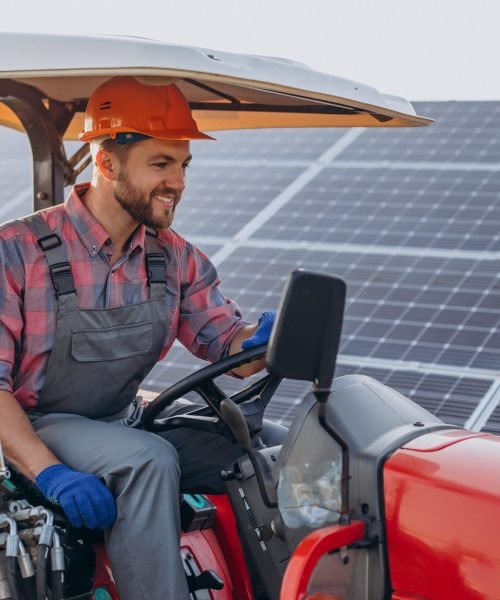 man-truck-driving-by-solar-panels-min-scaled.jpg
