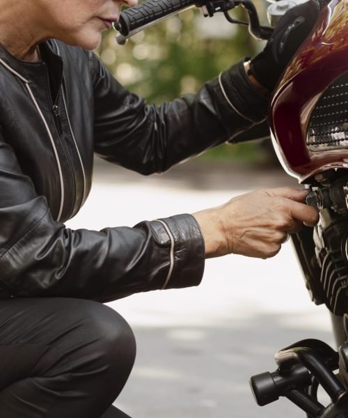 side-view-cool-old-woman-with-motorcycle-min