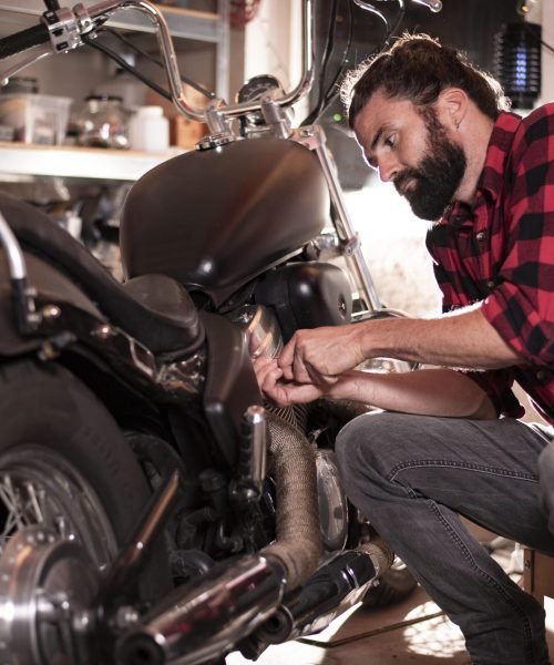 young-man-repairs-motorcycle-min